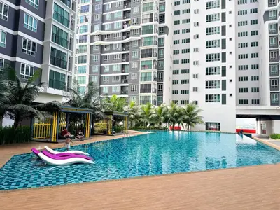 a swimming pool with a slide in front of tall buildings at Mountain City View 3BR Condo with Swimming Pool & Free WiFi Netflix in Kuala Lumpur