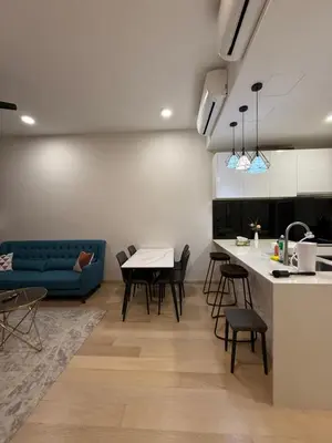 a kitchen and living room with a couch and a table at KL Star Residences By Nexus Nest 25 in Kuala Lumpur