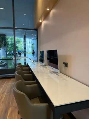 an office with a large white counter with chairs at KL Star Residences By Nexus Nest 25 in Kuala Lumpur