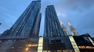a group of tall skyscrapers in a city at KL Star Residences By Nexus Nest 25 in Kuala Lumpur