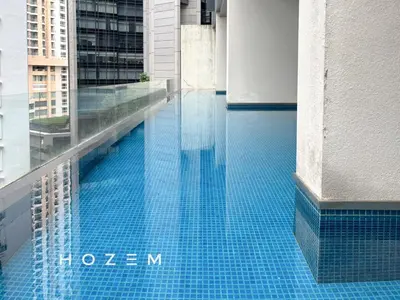 a blue swimming pool on the side of a building at 2BR3B Hozem KL1602 Apartment KLCC in Kuala Lumpur