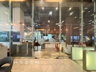 a lobby with glass doors and chairs in a building at 2BR3B Hozem KL1602 Apartment KLCC in Kuala Lumpur