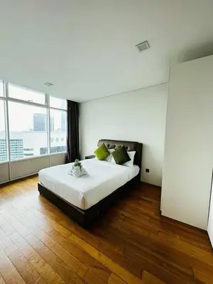 a bedroom with a large bed with a large window at Vortex suites Klcc by stuning vibes in Kuala Lumpur