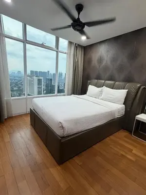 a bedroom with a bed with a ceiling fan at Vortex suites Klcc by stuning vibes in Kuala Lumpur