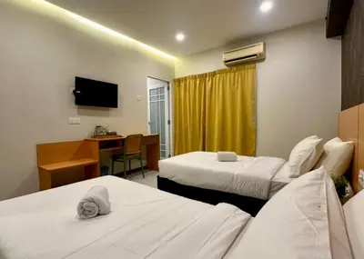 a hotel room with two beds and a desk at Swing & Pillows - Imbi Bukit Bintang in Kuala Lumpur