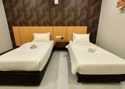two beds sitting next to each other in a room at Swing & Pillows - Imbi Bukit Bintang in Kuala Lumpur