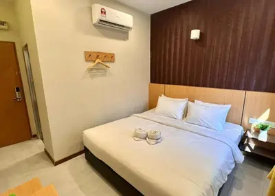 a hotel room with a bed with two candles on it at Swing & Pillows - Imbi Bukit Bintang in Kuala Lumpur