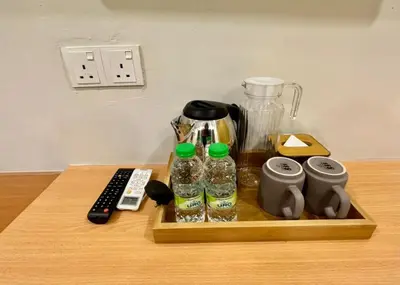 a wooden tray with a blender and other items on a table at Swing & Pillows - Imbi Bukit Bintang in Kuala Lumpur