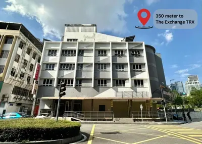 a building on a street with a traffic light at Swing & Pillows - Imbi Bukit Bintang in Kuala Lumpur