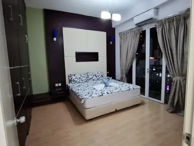 a bedroom with a bed and a large window at Seri Bukit Ceylon Bukit Bintang in Kuala Lumpur