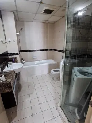 a bathroom with a shower and a sink and a toilet at Seri Bukit Ceylon Bukit Bintang in Kuala Lumpur