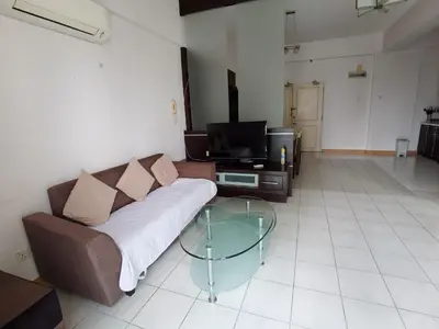 a living room with a couch and a glass table at Seri Bukit Ceylon Bukit Bintang in Kuala Lumpur