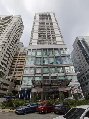 a tall building with cars parked in front of it at Seri Bukit Ceylon Bukit Bintang in Kuala Lumpur