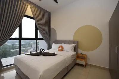 a bedroom with a bed with a large window at Trion KL by CityNest in Kuala Lumpur