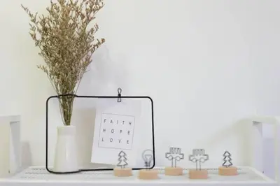a table with a vase of flowers and a sign at NEW 2BR KL Gateway LRT Midvalley and KLCC, KL Sentral in Kuala Lumpur