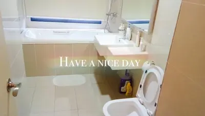a bathroom with a sink and a toilet with the words have a nice day at NEW 2BR KL Gateway LRT Midvalley and KLCC, KL Sentral in Kuala Lumpur