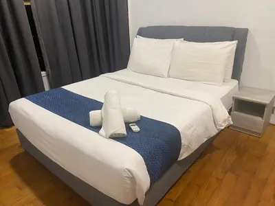 a bed with two pillows on top of it at Sky Suites KLCC By Stay Happy in Kuala Lumpur
