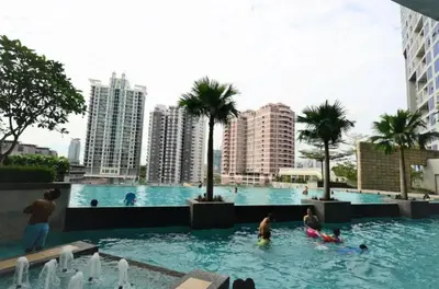 a group of people in a swimming pool in a city at Putra Suite KL in Kuala Lumpur