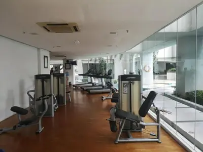 a gym with a row of exercise bikes in a room at Putra Suite KL in Kuala Lumpur