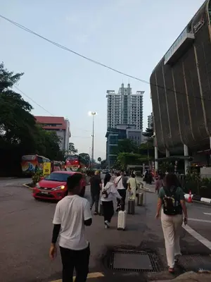 a group of people walking down a city street at Putra Suite KL in Kuala Lumpur