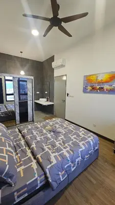 a bedroom with a large bed with a ceiling fan at Astoria Ampang City Centre in Kuala Lumpur