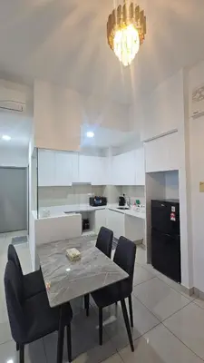 a kitchen with a table and chairs and a chandelier at Astoria Ampang City Centre in Kuala Lumpur