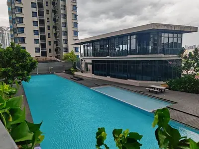a building with a swimming pool in front of a building at Astoria Ampang City Centre in Kuala Lumpur