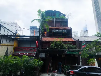 a man standing in front of a building at HOTEL I VILLA INN Bukit Bintang KL in Kuala Lumpur