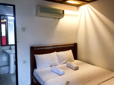 a bedroom with a bed with two pillows on it at HOTEL I VILLA INN Bukit Bintang KL in Kuala Lumpur