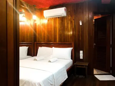 a bedroom with two beds and a heater on the wall at HOTEL I VILLA INN Bukit Bintang KL in Kuala Lumpur
