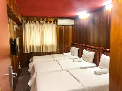 a bedroom with two beds with white sheets at HOTEL I VILLA INN Bukit Bintang KL in Kuala Lumpur