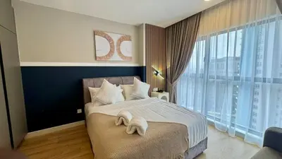 a bedroom with a bed with a towel on it at Warm & Cozy 2Bedroom Apartment at The Atrium Ampang by OKBnB in Kuala Lumpur