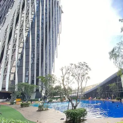 a large building with a swimming pool in front of it at Arte Mont Kiara by Skyline in Kuala Lumpur