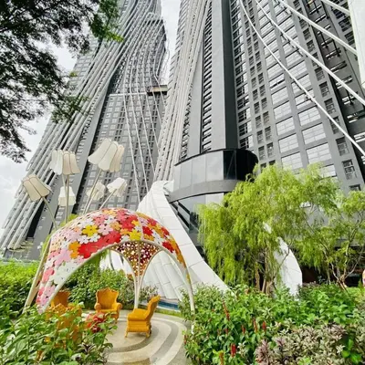 a garden in front of some tall buildings at Arte Mont Kiara by Skyline in Kuala Lumpur