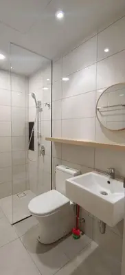 a white bathroom with a toilet and a sink at Arte Mont Kiara by Skyline in Kuala Lumpur