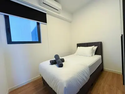 a bedroom with a bed with a teddy bear on it at M Vertica KL City Fully Air-Con Home in Kuala Lumpur