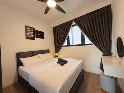 a bedroom with a black teddy bear sitting on a bed at M Vertica KL City Fully Air-Con Home in Kuala Lumpur