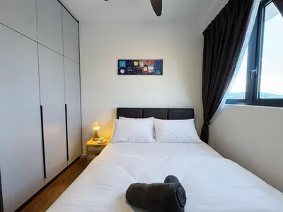 a bedroom with a white bed with a large window at M Vertica KL City Fully Air-Con Home in Kuala Lumpur