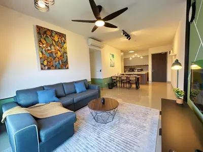 a living room with a blue couch and a table at M Vertica KL City Fully Air-Con Home in Kuala Lumpur