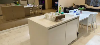 a kitchen and living room with a white counter top at platinum suites klcc By Palmas in Kuala Lumpur