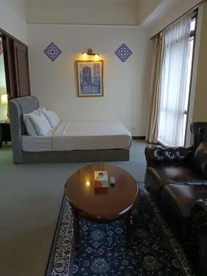 a living room with a bed and a couch and a coffee table at Crown Suits At Times Square in Kuala Lumpur