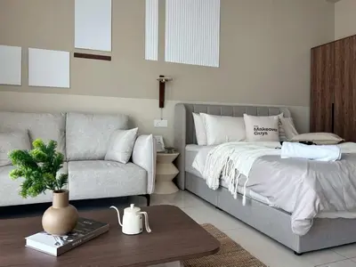a bedroom with a bed and a couch and a table at Elegant Studio - Upscale Neighbourhood of Hartamas in Kuala Lumpur