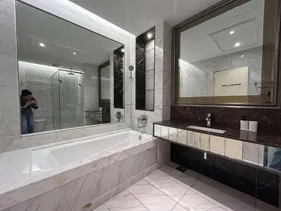 a person taking a picture of a bathroom with a tub at Elegant Studio - Upscale Neighbourhood of Hartamas in Kuala Lumpur