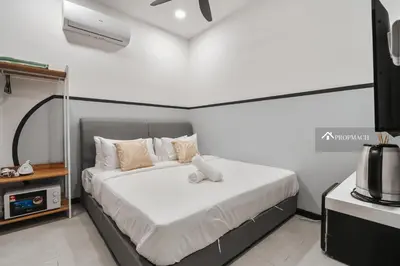 a bedroom with a bed and a tv in it at Neu Suites By Propmach in Kuala Lumpur