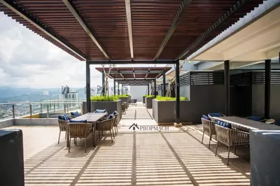 a restaurant with tables and chairs on a balcony at Neu Suites By Propmach in Kuala Lumpur