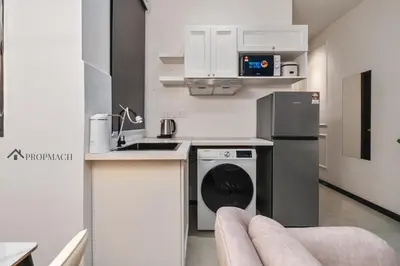 a kitchen with a refrigerator and a dishwasher at Neu Suites By Propmach in Kuala Lumpur