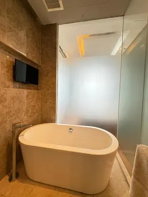 a large bath tub in a bathroom with a tv at Crystal Dorsett Infinity Pool KL in Kuala Lumpur