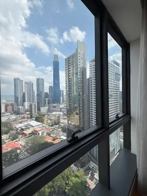 a view of a city skyline from a window at Crystal Dorsett Infinity Pool KL in Kuala Lumpur