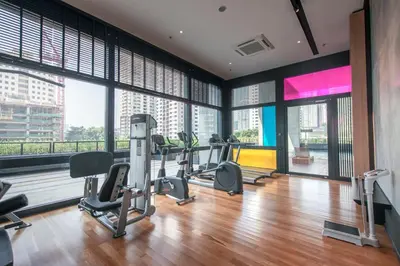 a gym with tread machines and large windows at netflix&chill Arcoris Soho 2R1B Mont Kiara in Kuala Lumpur