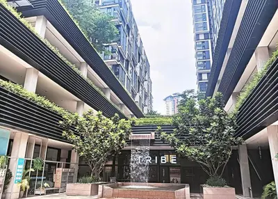 a building with trees in the middle of a city at netflix&chill Arcoris Soho 2R1B Mont Kiara in Kuala Lumpur